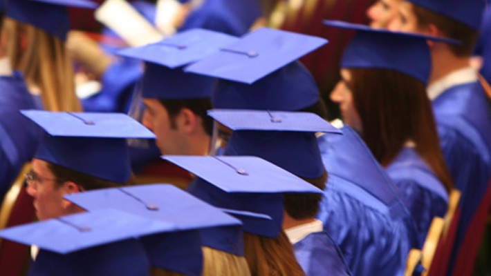 A crowd of graduates in caps and gowns.