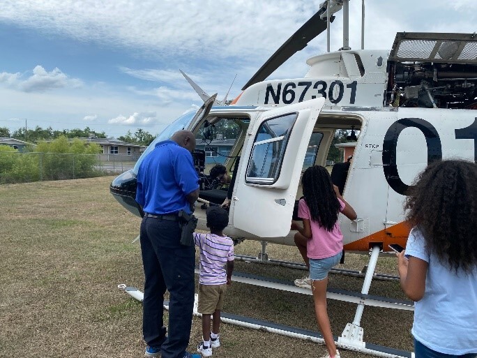 Kids getting into a helicopter.