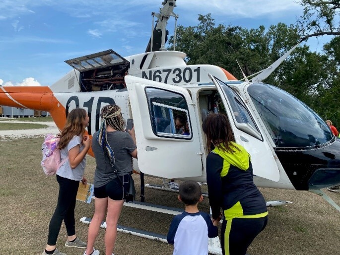 Kids looking at a helicopter.