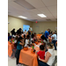 Families attending the fall festival, painting pumpkins and doing crafts.