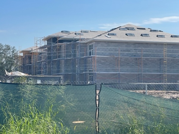 Building surrounded by two story scaffolding.