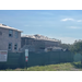 Long view of construction of wall being put up.