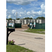 Street view of construction site from across the street, beginning of building and security fence.