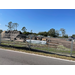 View from across the street of the materials delivered to the construction site.