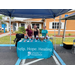 Three women standing for a photo behind a table that reads Help. Hope. Healing. SPARCCC.