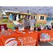 A man and a woman from South Florida State College, standing under their tradeshow tent. 