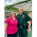 Woman standing next to an officer outside a tradeshow tent. 