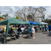 A row of tradeshow tents with people walking around. 