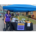 Woman standing next to a table with tradeshow materials with a sign that reads Suncoast, The Campaign for Grade-Level Reading