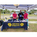 Three people pose at the Arcadia police table.