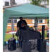 A DJ is under a tent.