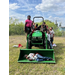 Children pose on a tractor.