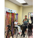 A child sits in a chair in front of a camera.