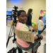 A child sits in a director's chair.