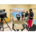Kids and adults working on a camera set.