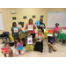A group of youth pose with their paintings.