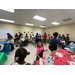A wide view of the kids painting.