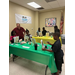 Kids paint at tables.