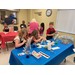 A group of kids working on paintings.