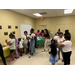 Kids painting while adults assist them.
