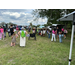  People standing around petting animals.  