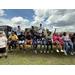  A large group of kids sitting on a trailer for a picture. 