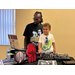  A young boy smiling with DJ SKUBII. 