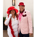  Becky-Sue dressed up with a hat and glasses next to a man in a hat, smiling for a photo. 