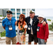  Four people pose with arms around each other smiling for a photo. 
